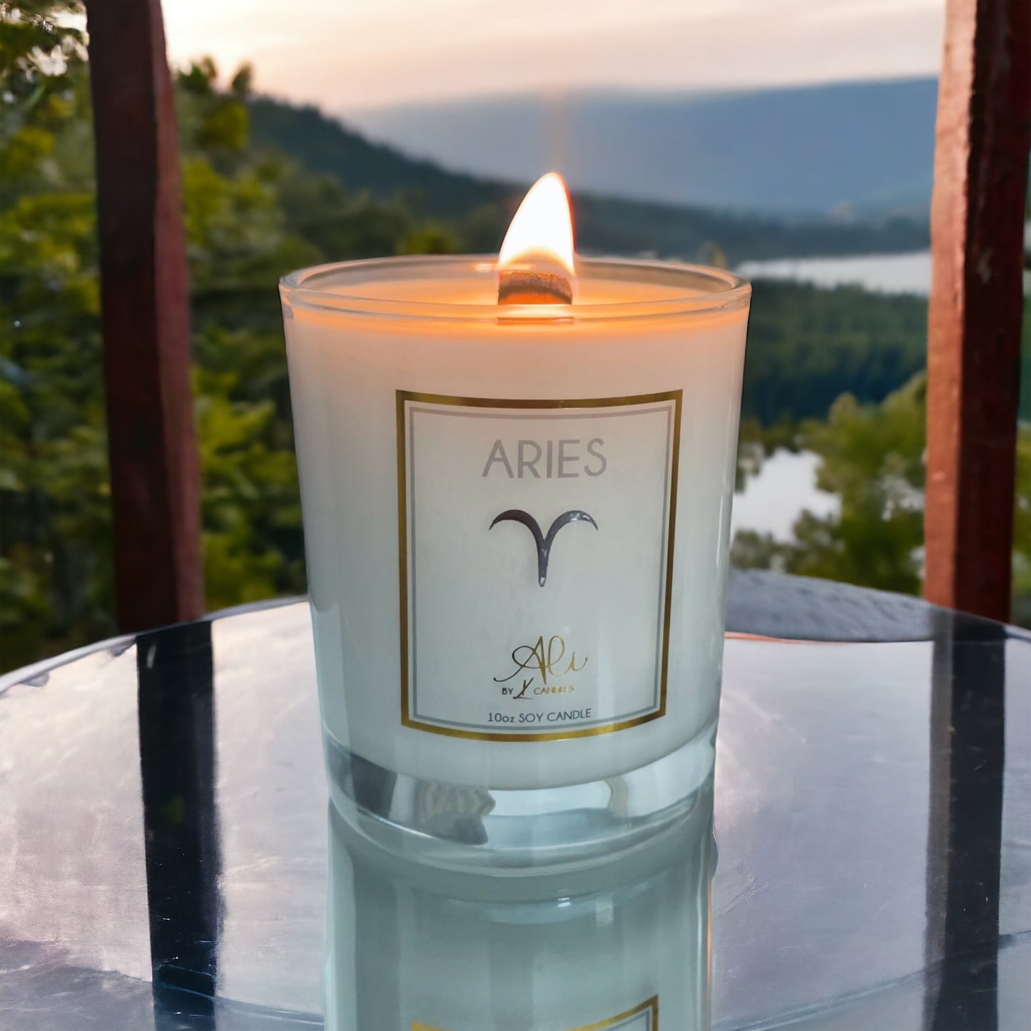 aries lit candle with Canadian mountains in the background