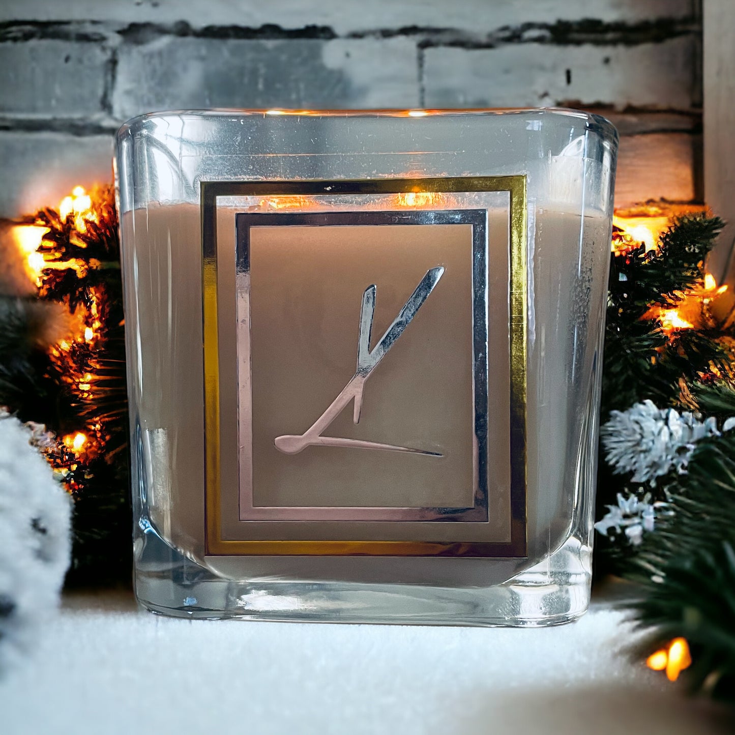 Warm Candle against a snowy winter scene. Best selling Karys Layne candle. 