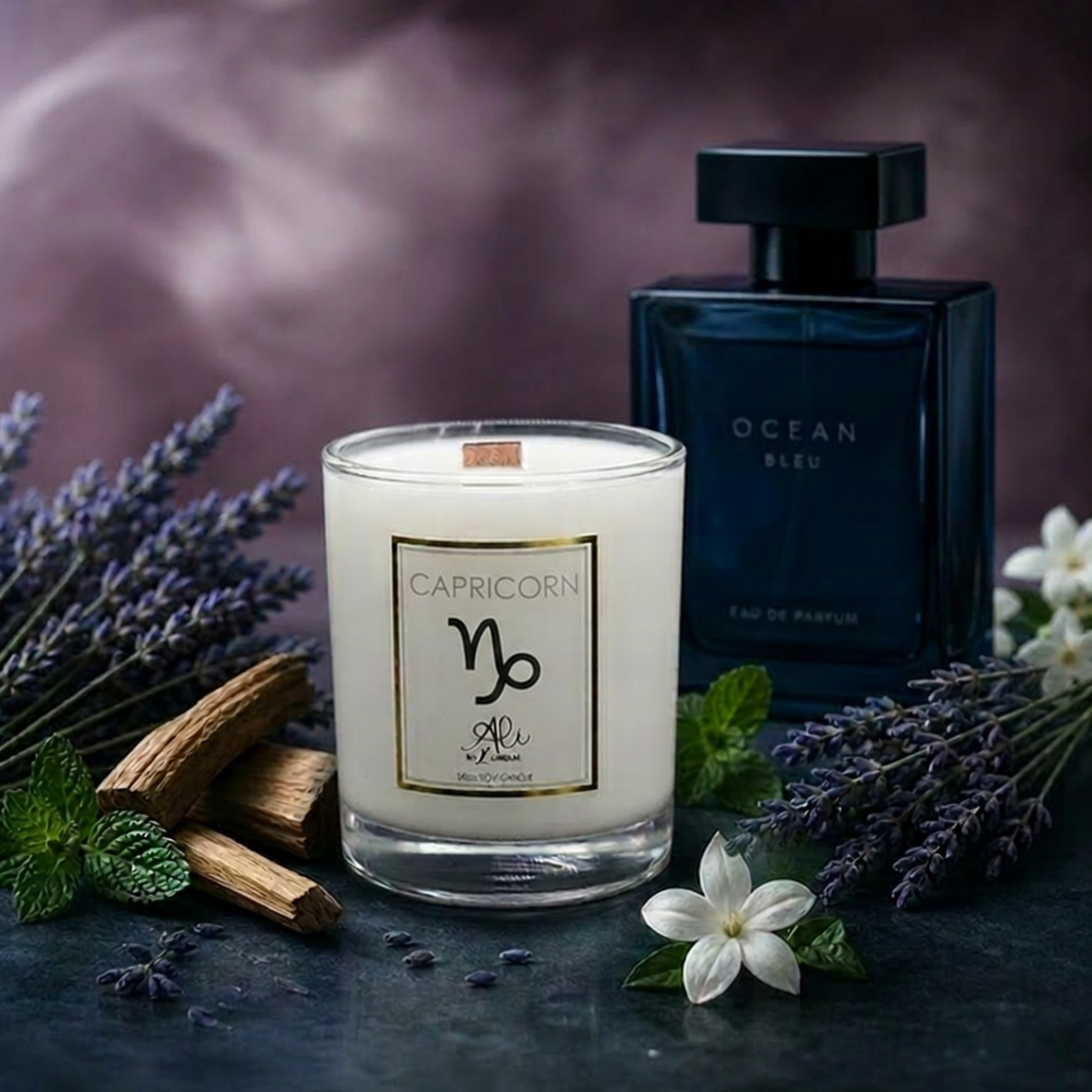 Candle labeled 'Capricorn' with perfume bottle and lavender flowers on a dark surface.