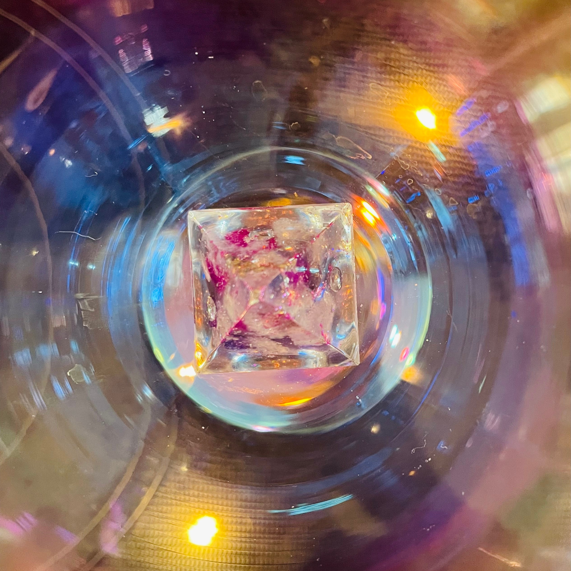 crystal organite illuminated with ethereal lights on a reflective surface