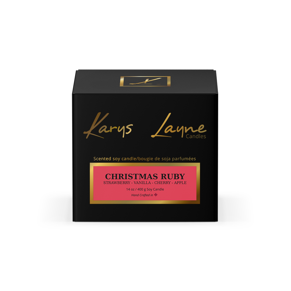 A black box of Karys Layne Candles with the label 'Christmas Ruby' showing the scent profile of sweet berries, vanilla, almond and peach. 